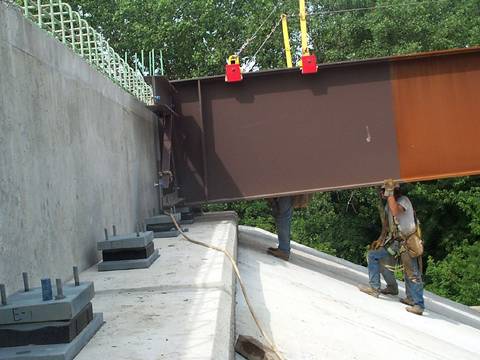 Several workers are replacing high damping rubber bearing on bridge.