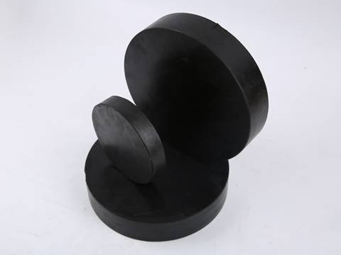Three different sizes round shape laminated bearing pads on gray background.