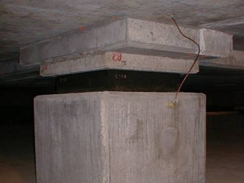 A large rectangular laminated bearing pad is placed on the pier directly.